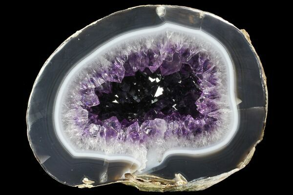 A cut & polished amethyst geode from Uruguay showing the layers of chalcedony that built up prior to crystal formation.